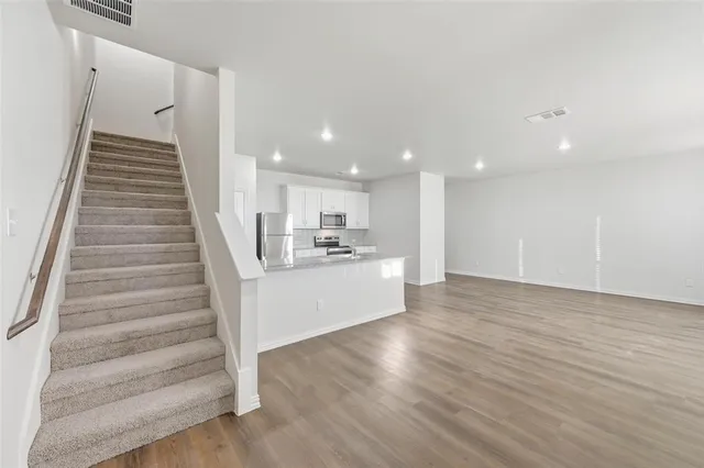 a view of an entryway with wooden floor