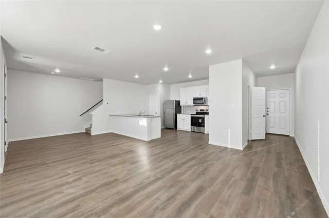 a view of kitchen with stainless steel appliances refrigerator microwave and stove