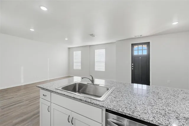 a kitchen with a sink and cabinets