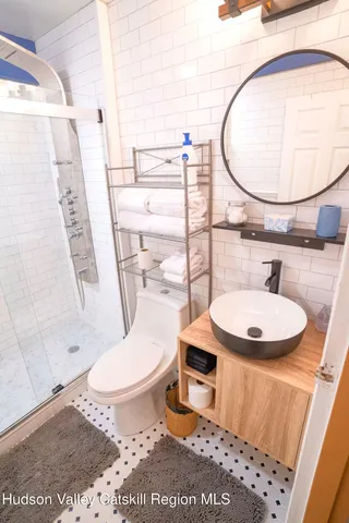 a bathroom with a sink toilet and mirror
