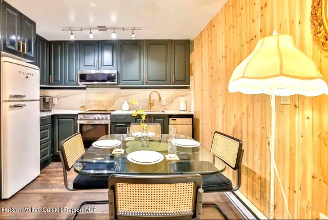 a kitchen with a table chairs and a stove