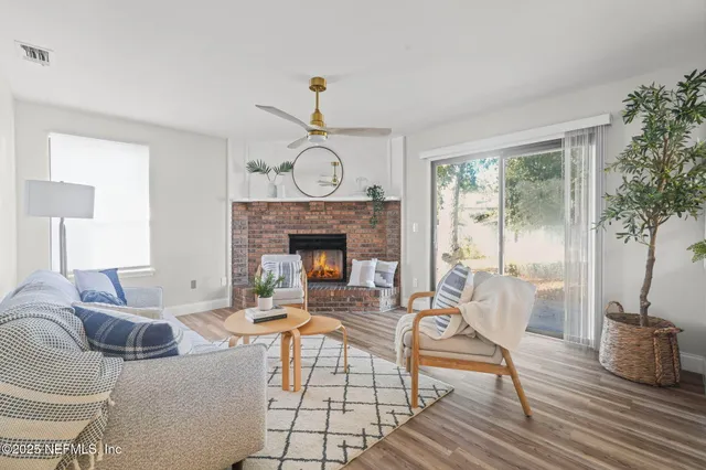 a living room with furniture a window and a fireplace