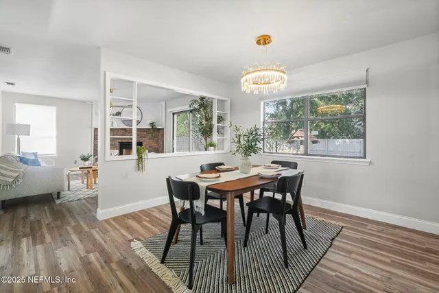 a view of a dining room with furniture window and wooden floor
