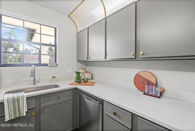 a kitchen with a sink and cabinets