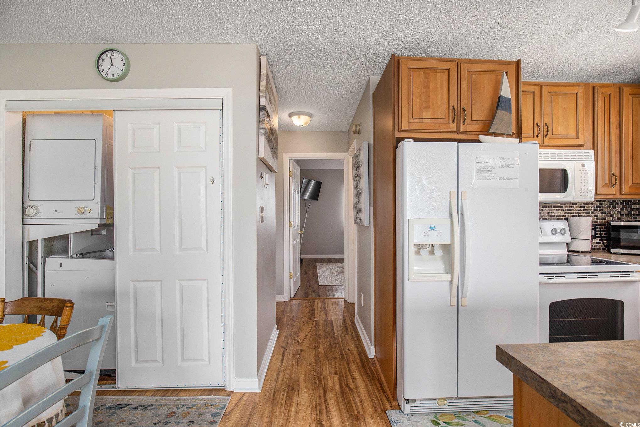 3700 Golf Colony Lane, Unit 14P Little River, SC 29566 - Photo 15 of 30 Kitchen with brown cabinets, white appliances, a t