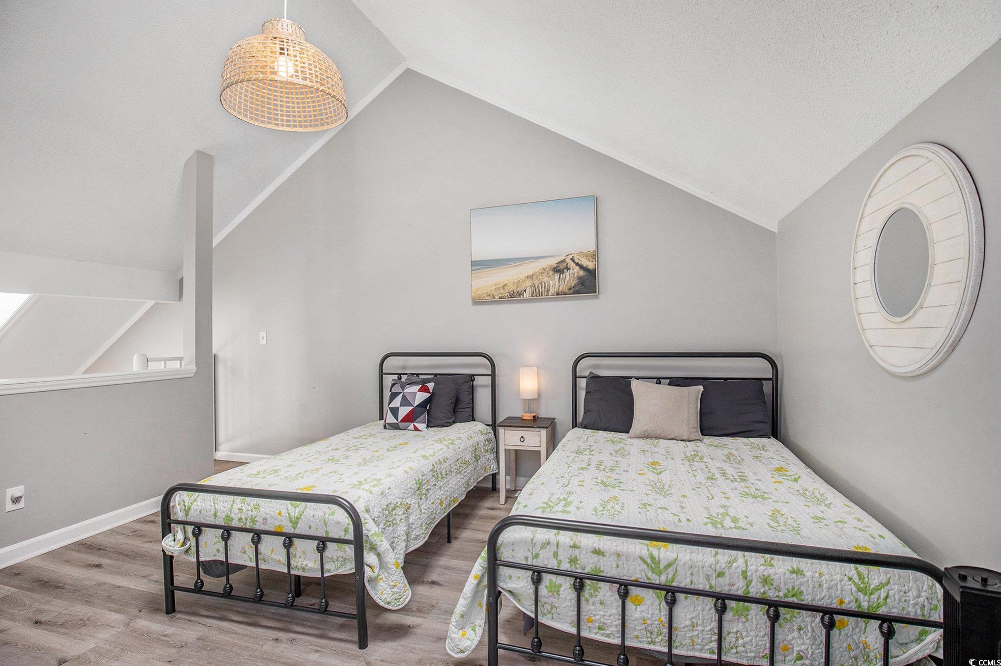 3700 Golf Colony Lane, Unit 14P Little River, SC 29566 - Photo 23 of 30 Bedroom with vaulted ceiling and wood finished flo