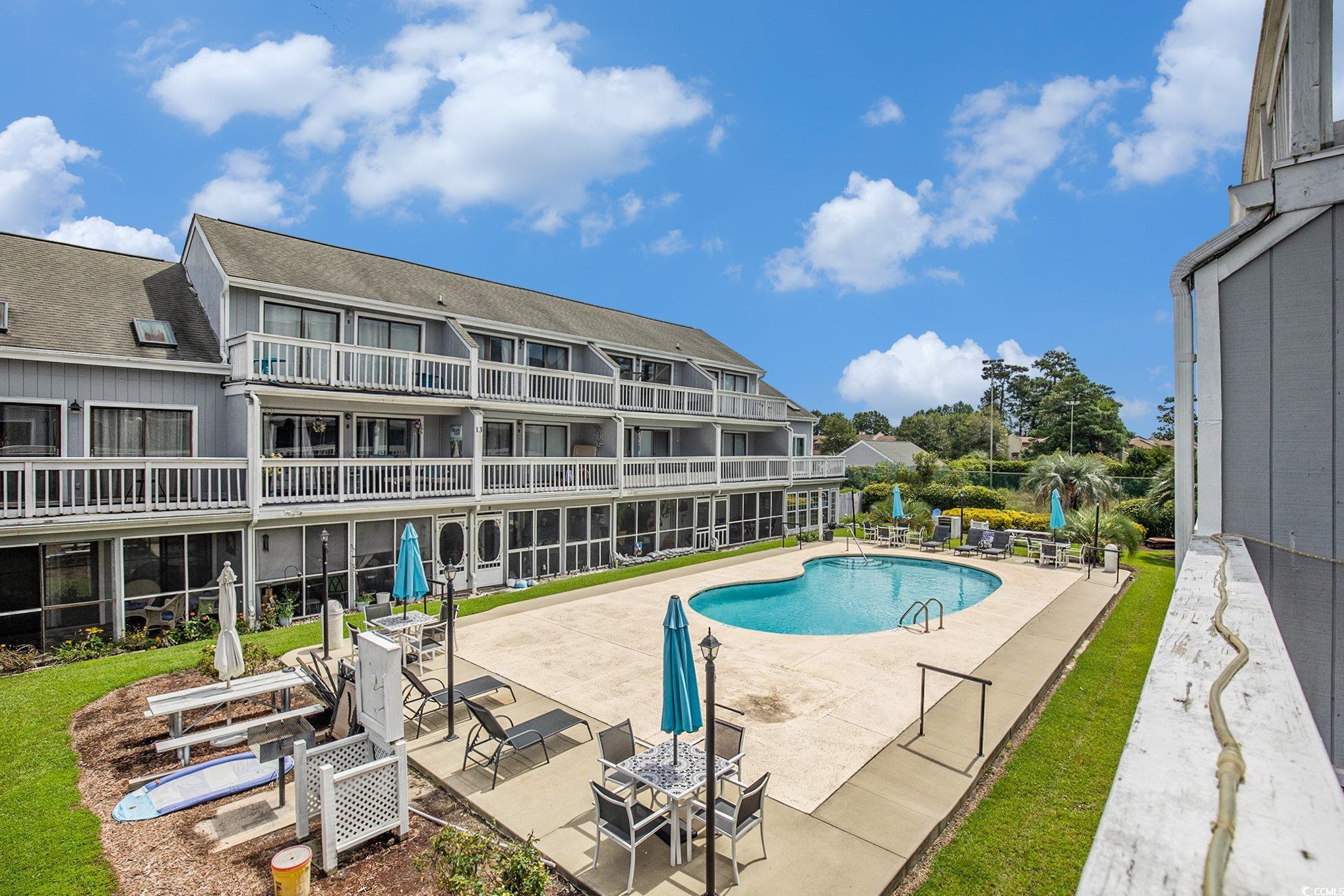 3700 Golf Colony Lane, Unit 14P Little River, SC 29566 - Photo 29 of 30 Community pool featuring a patio area and a balcon