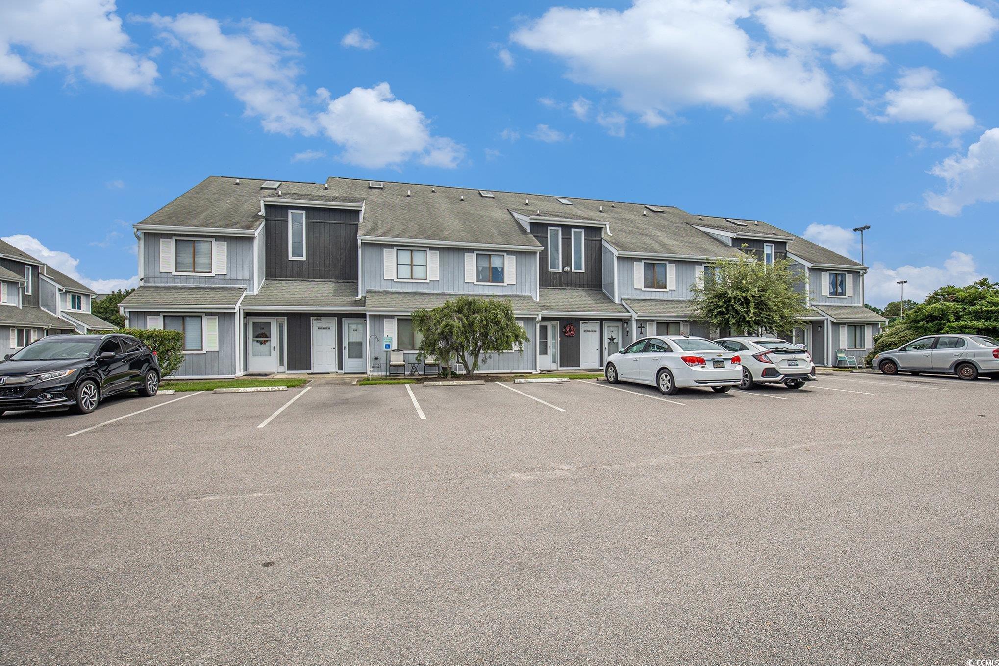 3700 Golf Colony Lane, Unit 14P Little River, SC 29566 - Photo 3 of 30 View of property featuring uncovered parking and a