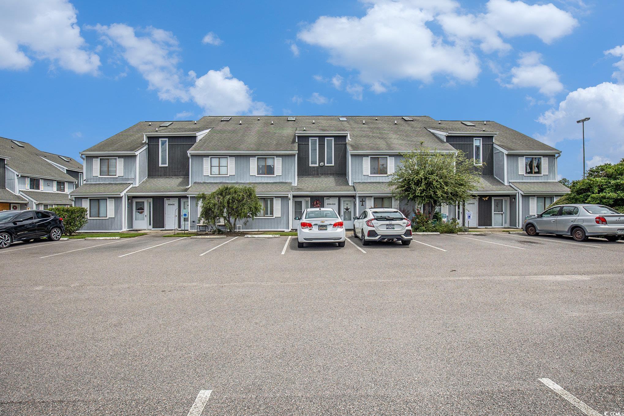 3700 Golf Colony Lane, Unit 14P Little River, SC 29566 - Photo 4 of 30 View of property featuring uncovered parking and a