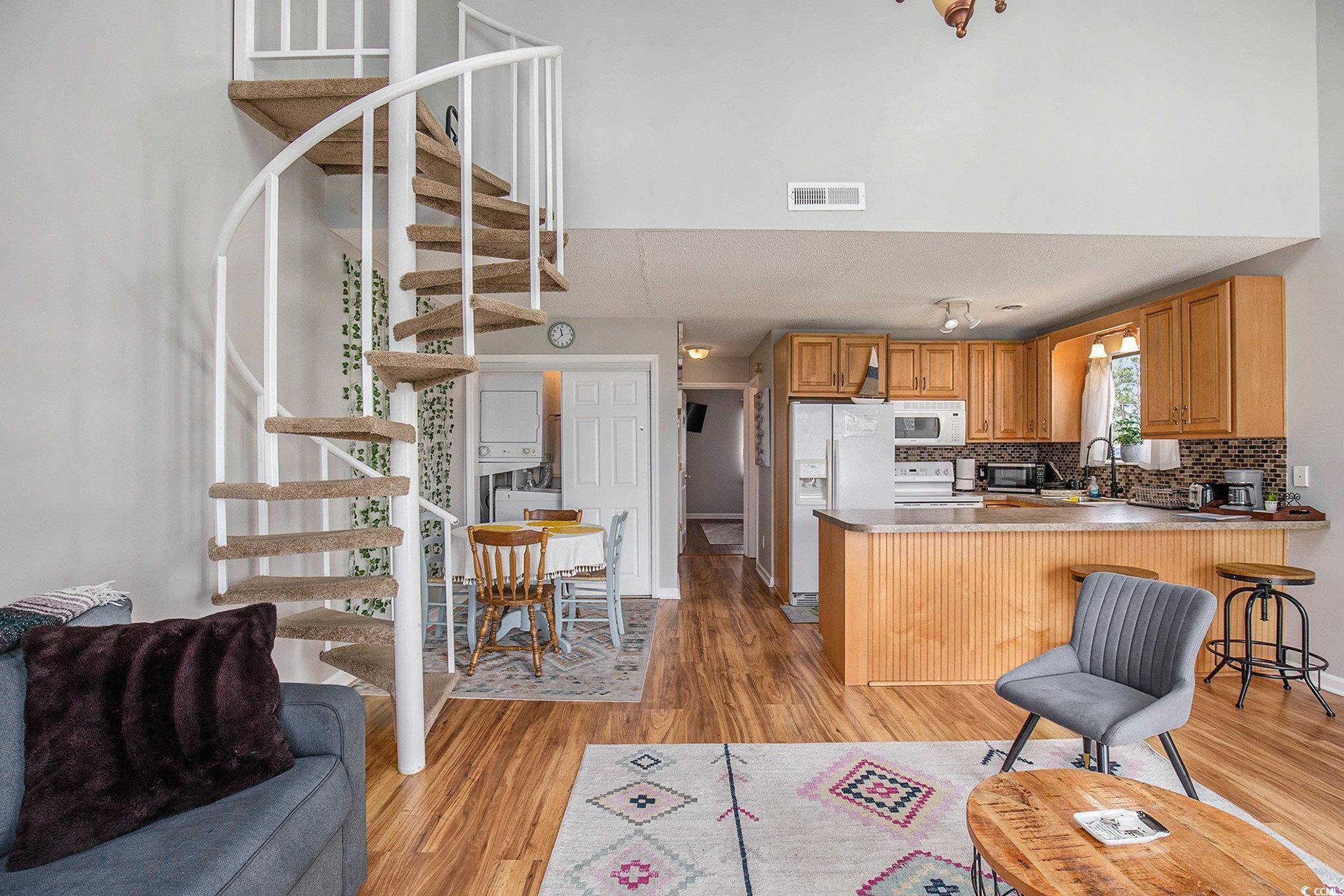 3700 Golf Colony Lane, Unit 14P Little River, SC 29566 - Photo 8 of 30 Kitchen with light wood-style flooring, backsplash