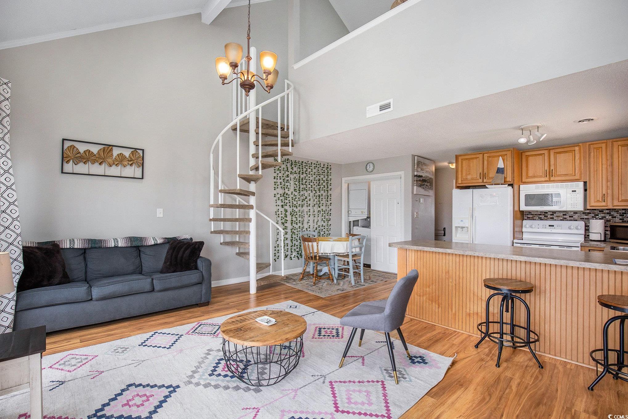 3700 Golf Colony Lane, Unit 14P Little River, SC 29566 - Photo 9 of 30 Living room with stairway, light wood-type floorin