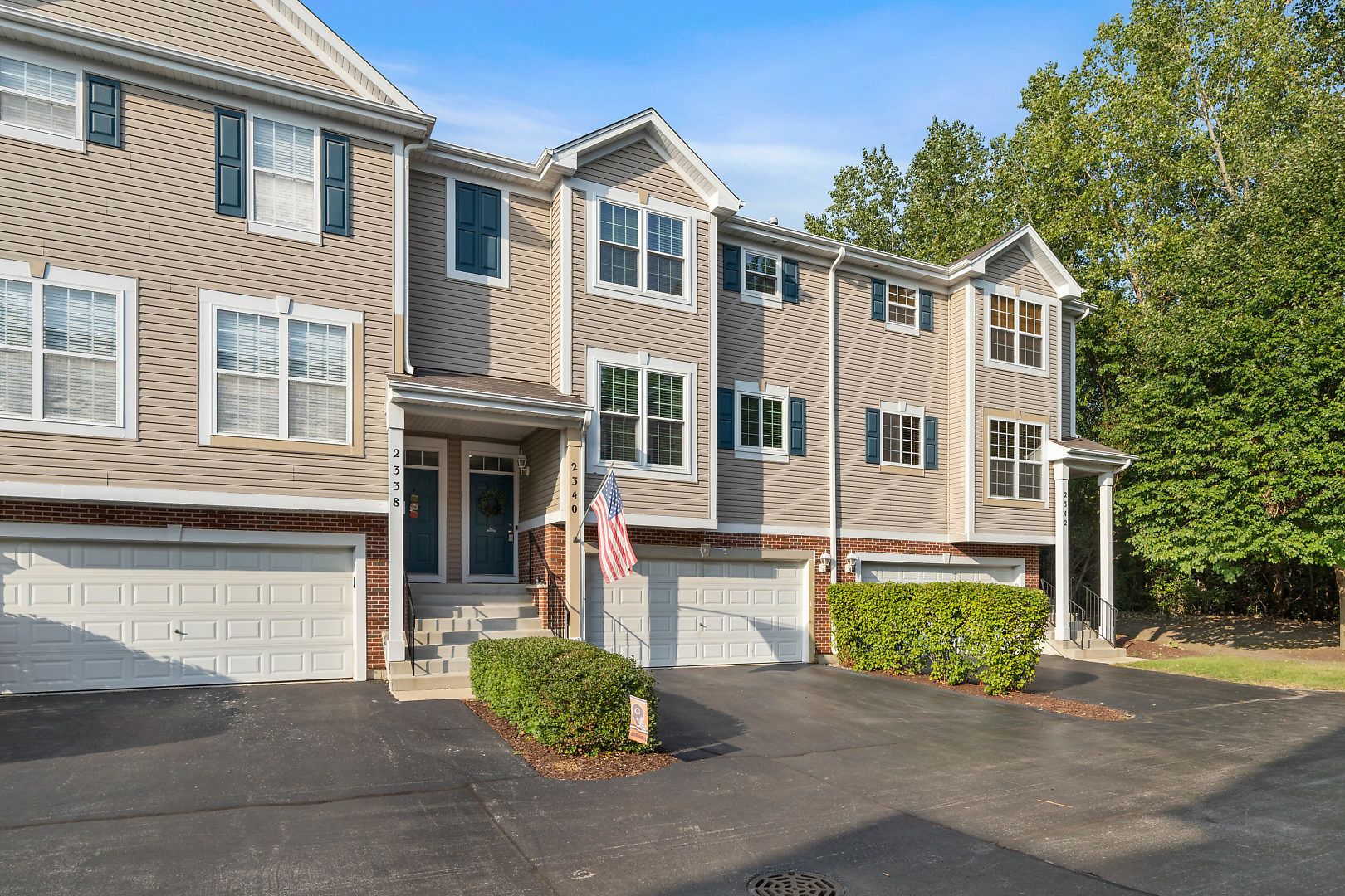 a front view of a house with a yard and outdoor seating