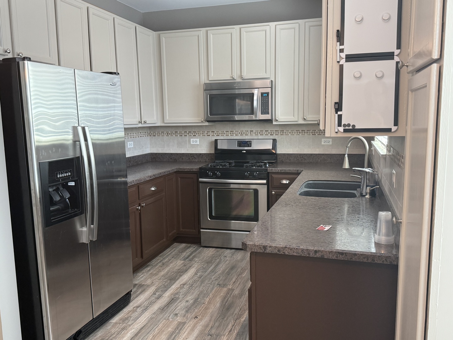 2340 Hudson Circle Aurora, IL 60502 - Photo 11 of 37 a kitchen with granite countertop a refrigerator stove and microwave
