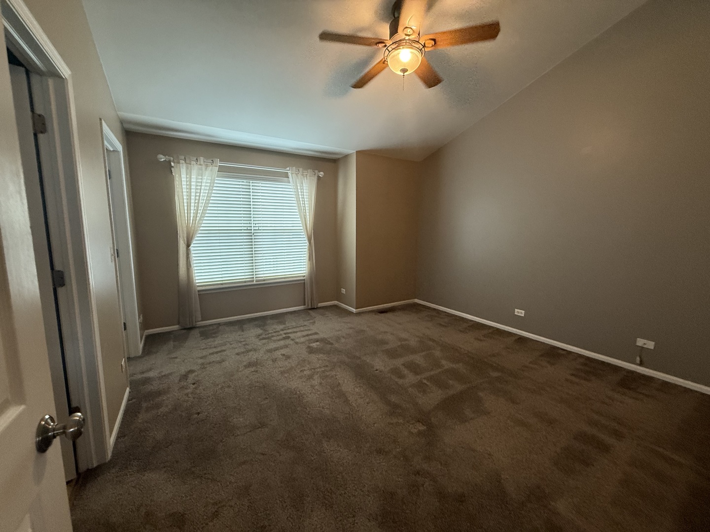 2340 Hudson Circle Aurora, IL 60502 - Photo 16 of 37 an empty room with windows and fan