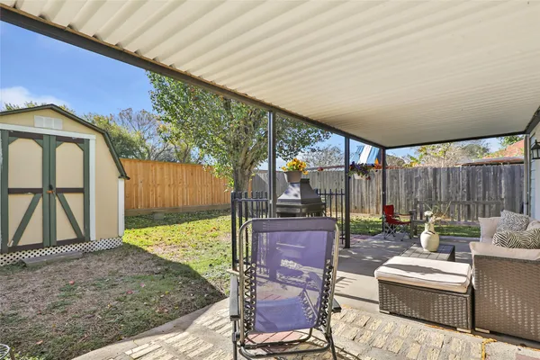 a backyard of a house with outdoor seating
