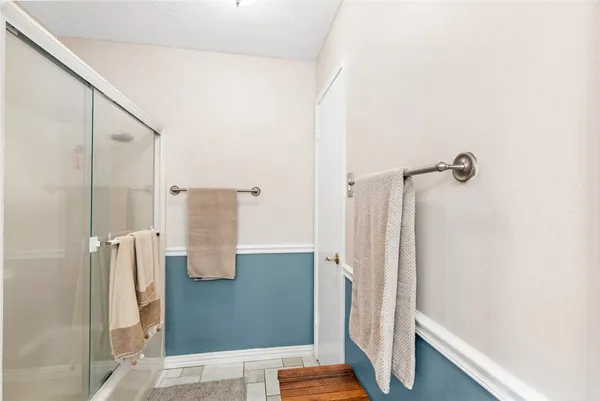 a bathroom with a shower and a mirror