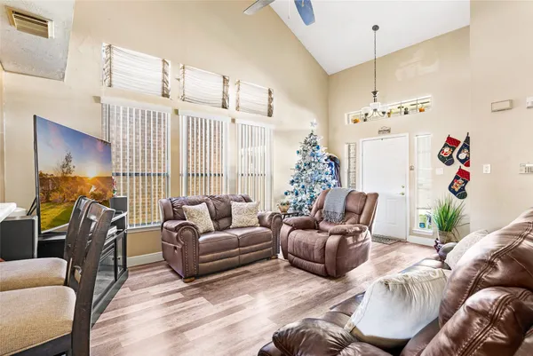 a living room with furniture and a chandelier
