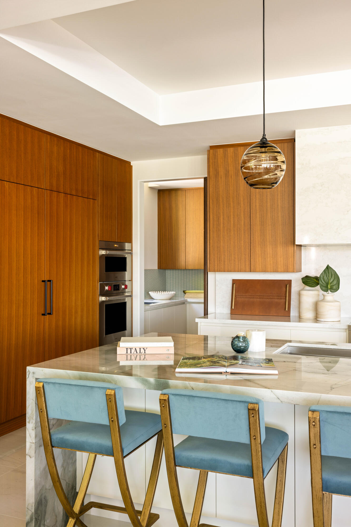 488 South Beach Road Jupiter Island, FL 33455 - Photo 16 of 54 a kitchen with a table chairs sink and cabinets
