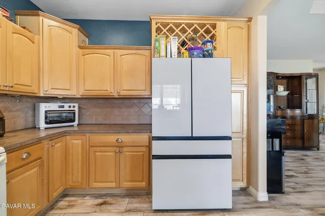 a kitchen with stainless steel appliances granite countertop a refrigerator and a stove