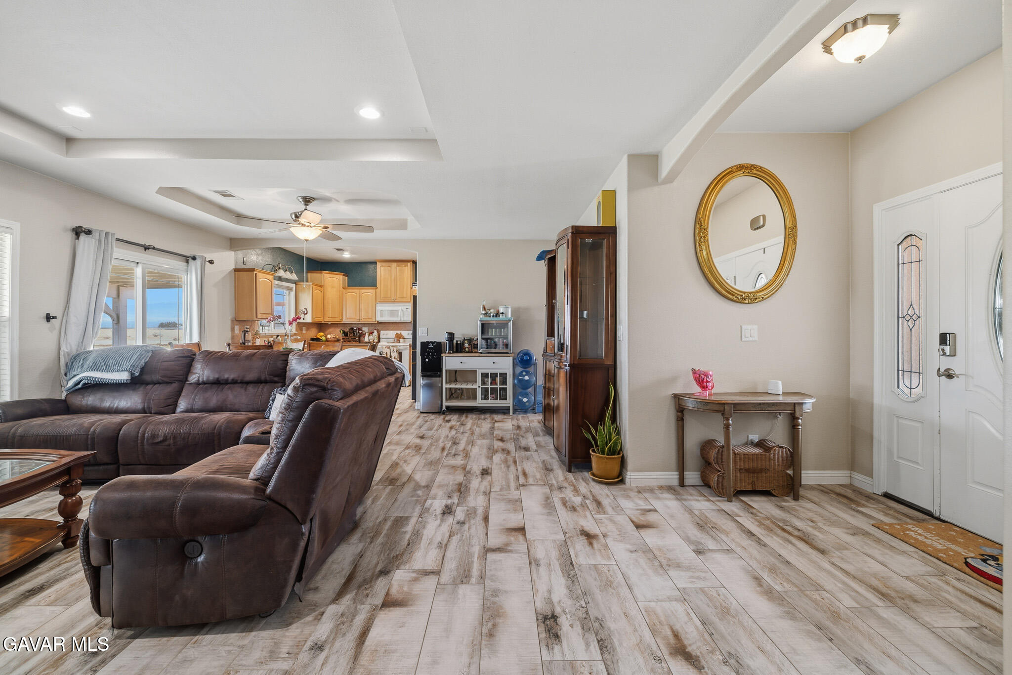 49945 80th Street West Lancaster, CA 93536 - Photo 14 of 38 a living room with furniture a clock on wall and a mirror