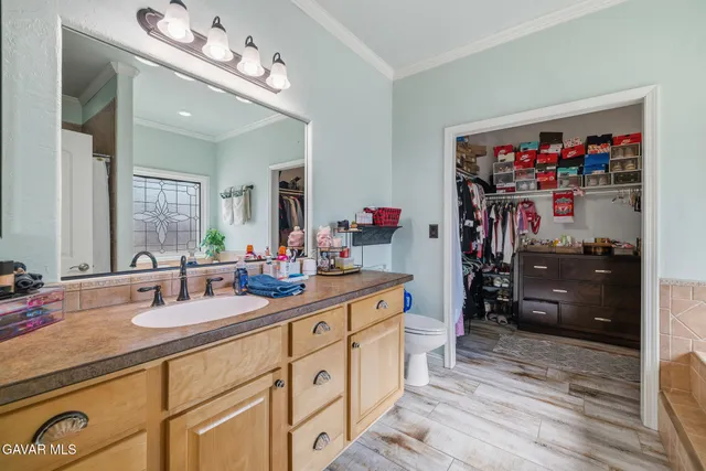a kitchen with sink refrigerator and cabinets