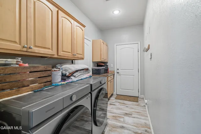 a kitchen with stainless steel appliances a refrigerator and cabinets