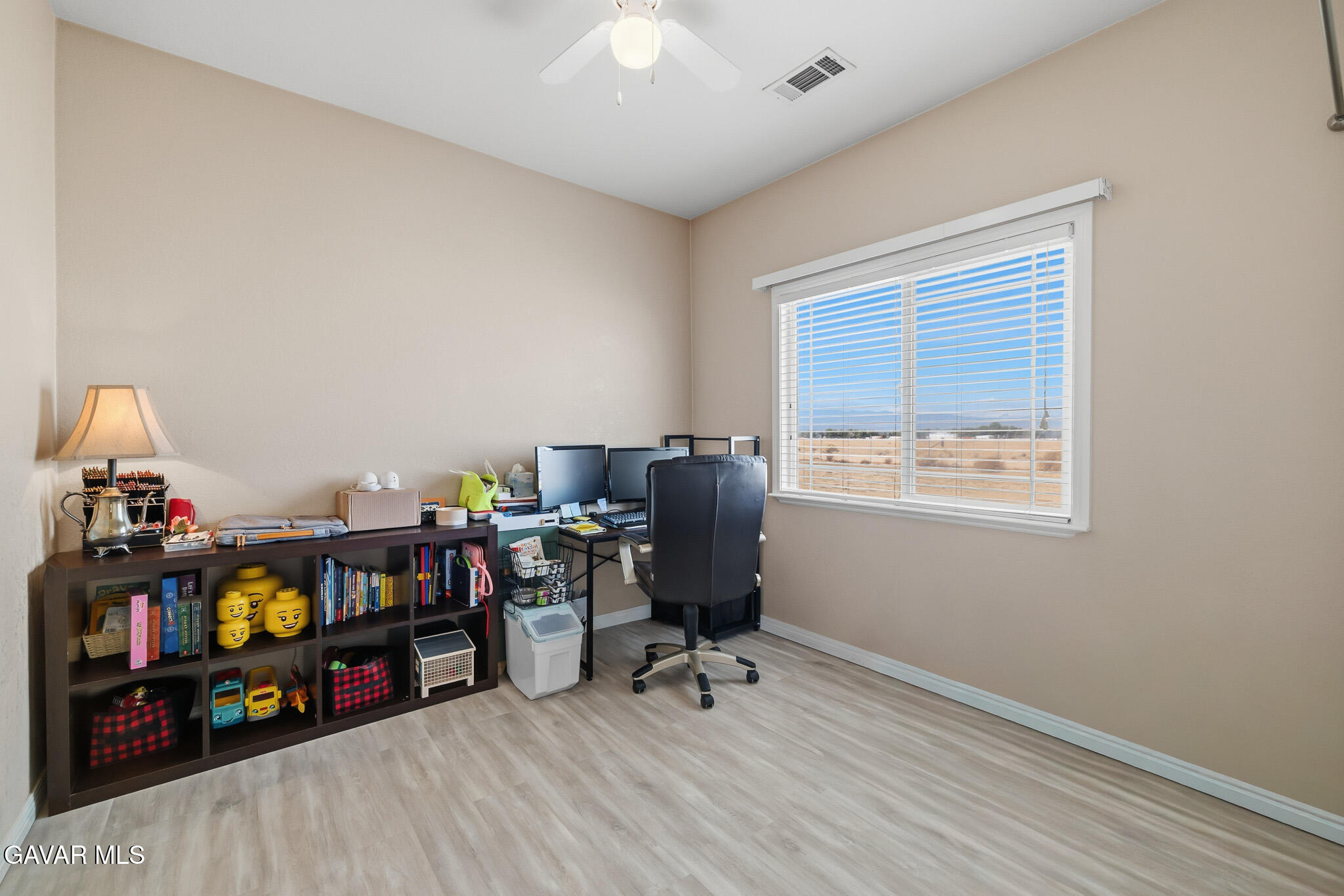 49945 80th Street West Lancaster, CA 93536 - Photo 25 of 38 a view of a workspace with furniture and a window