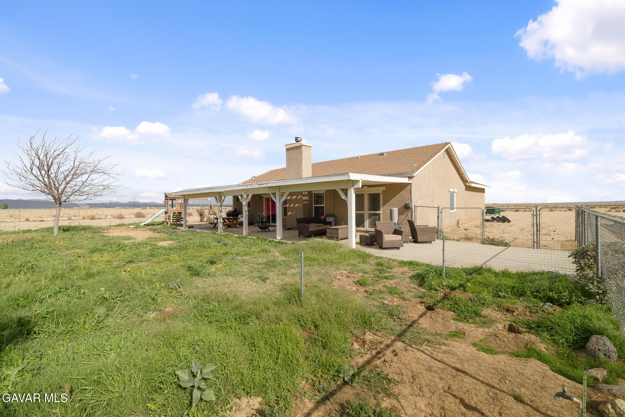 49945 80th Street West Lancaster, CA 93536 - Photo 27 of 38 a front view of a house with a yard