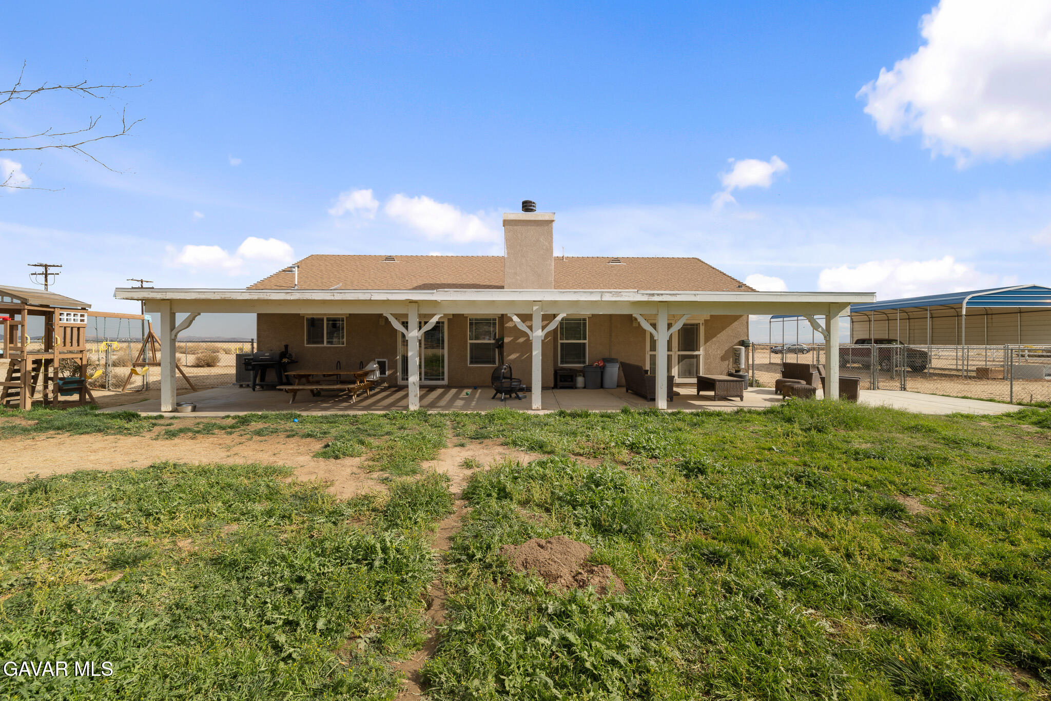49945 80th Street West Lancaster, CA 93536 - Photo 28 of 38 a front view of a house with a yard