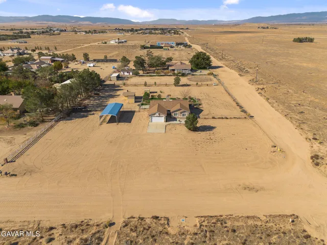 an aerial view of ocean and residential houses with outdoor space