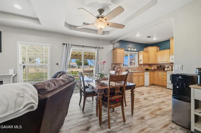 a living room with furniture kitchen and a large window