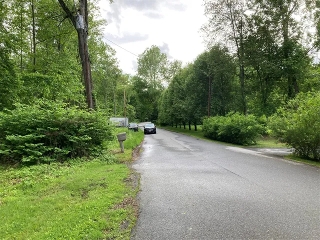 a view of a road with a yard