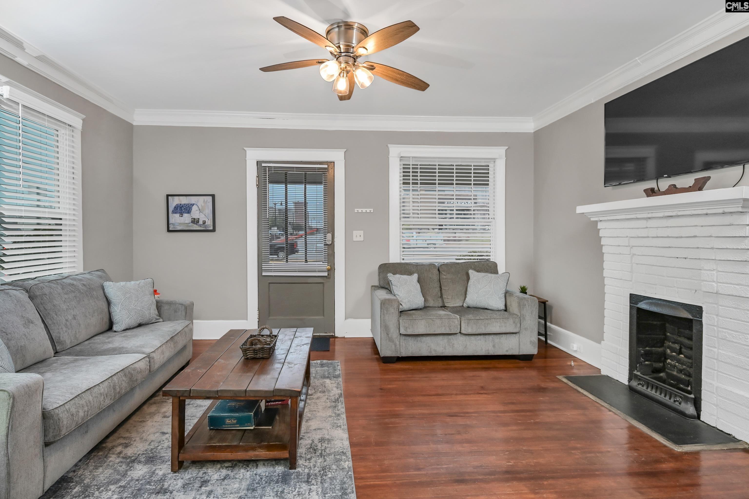2227 Bull Street Columbia, SC 29201 - Photo 5 of 38 a living room with furniture a flat screen tv and a fireplace