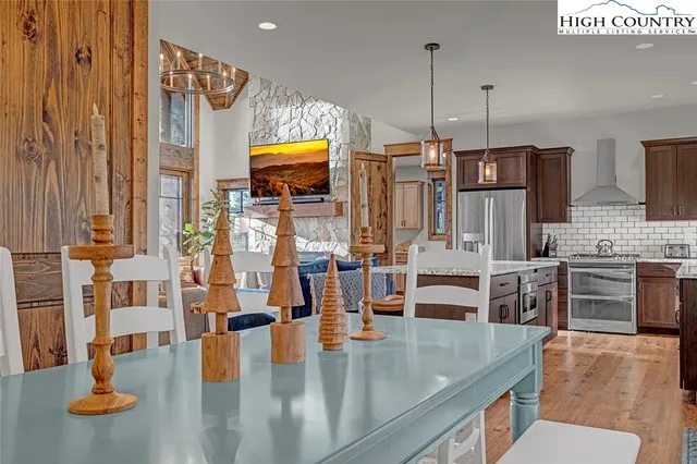 a kitchen with stainless steel appliances kitchen island granite countertop a stove and white cabinets