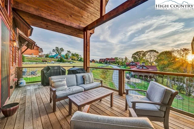 a roof deck with couches and wooden floor