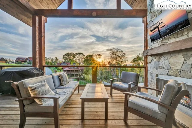 a view of a balcony with a couch and wooden floor