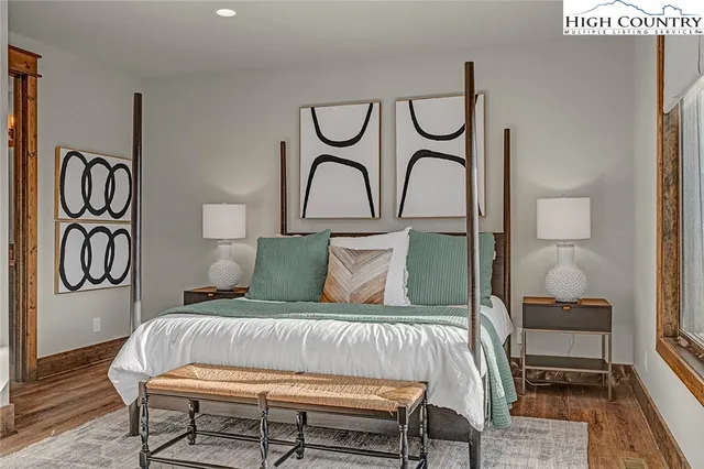 a bedroom with a bed and lamps