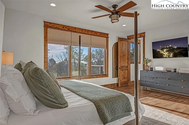 a bedroom with a large bed and a flat screen tv