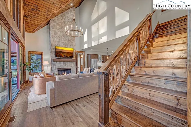 a living room with fireplace furniture and a wooden floor