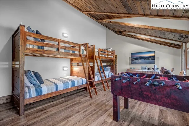 a bedroom with furniture and wooden floor