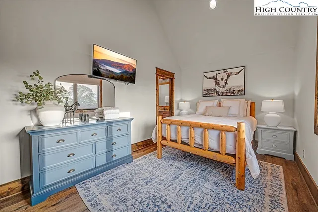 a bathroom with a granite countertop sink a mirror a toilet and shower