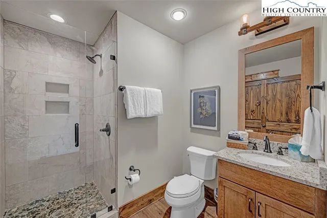 a bedroom with a bed and glass windows