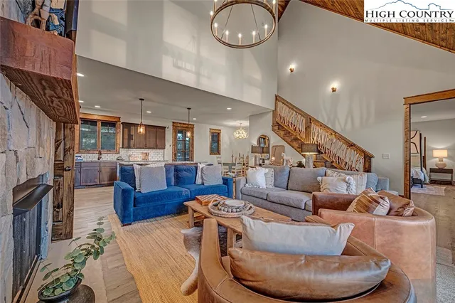 a living room with furniture and kitchen view