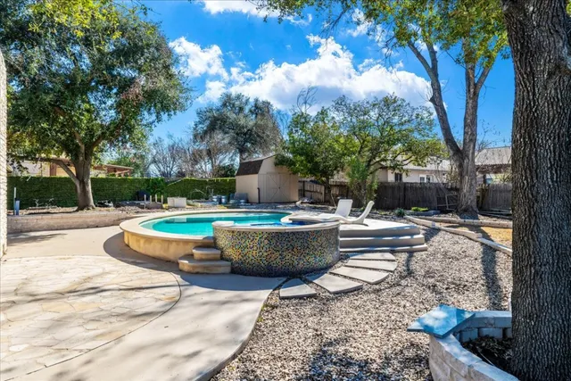 a view of a swimming pool with a lounge chairs