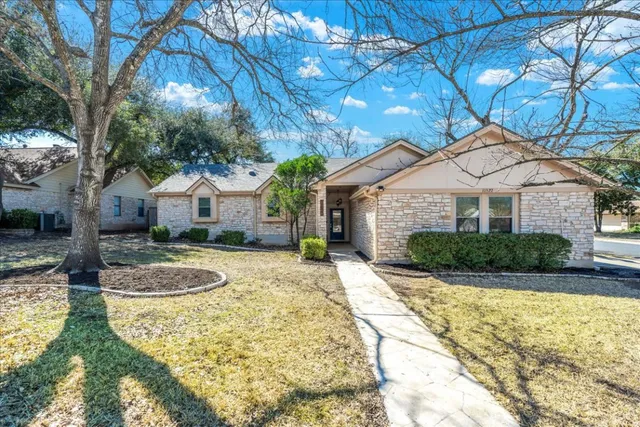 a front view of a house with yard patio and green space