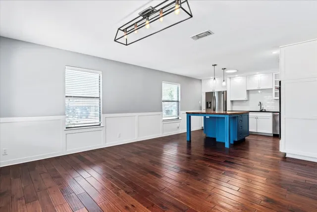 a view of kitchen with furniture and wooden floor