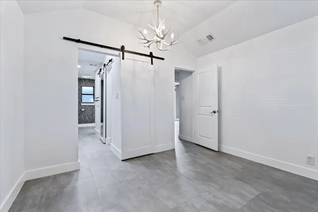 a view of a chandelier fan and entryway