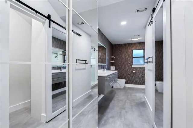 a large bathroom with a glass shower door
