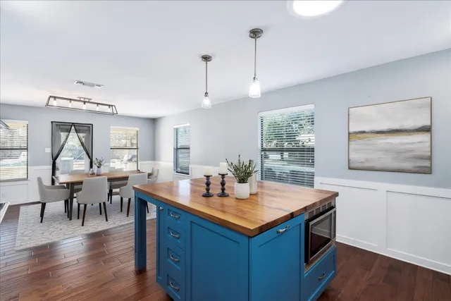 a kitchen with stainless steel appliances granite countertop a stove and a wooden floors