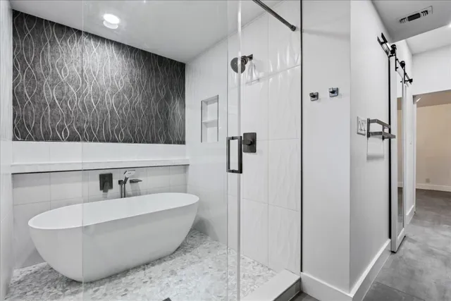 a bathroom with a bathtub and shower